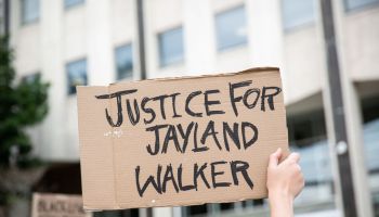 A protester holds a sign that says, "Justice for Jayland...