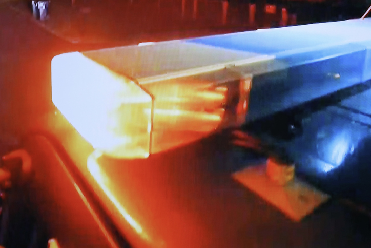 Speeding Police car on the freeway - close-up flashing lights