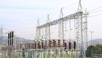 Power plant with pylons and high voltage cables.