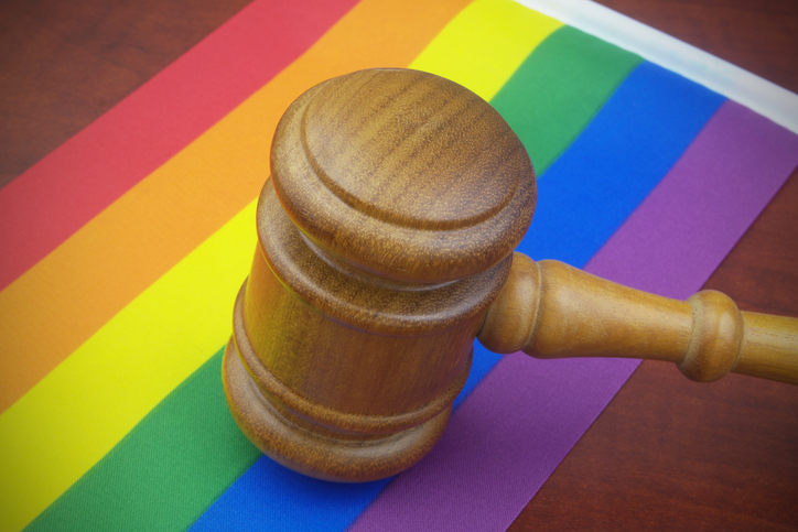 Wooden judge gavel on LGBT flags.