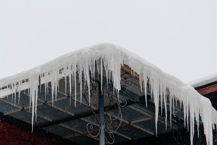 icicles on metal roof of building, danger to pedestrians
