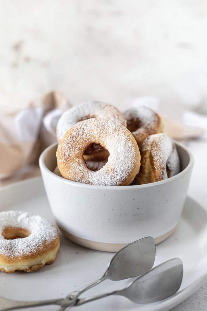 Food, Delicious homemade donuts with sugar on a white stone background. Selective focus